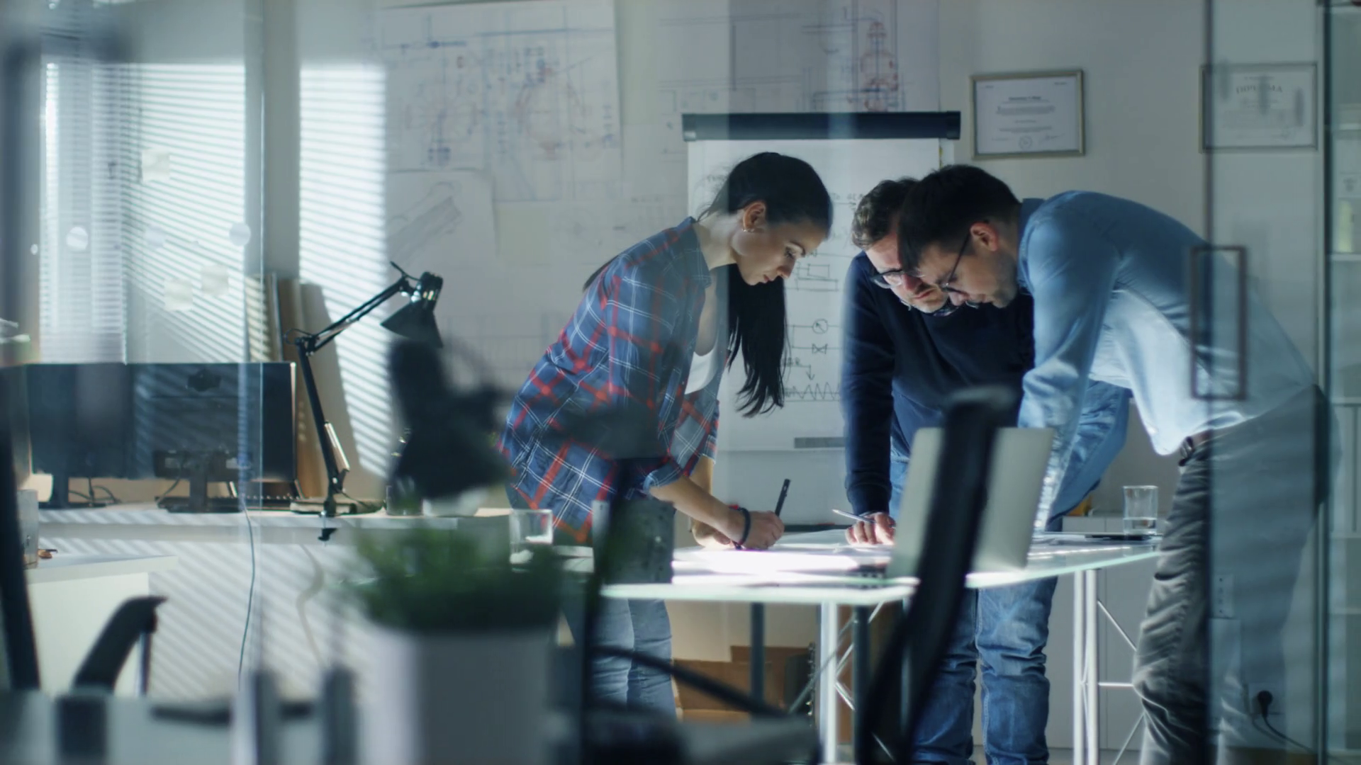 late-at-night-three-design-engineers-have-a-working-meeting-about-project-various-drafts-components-and-notebook-laying-on-the-table-shot-on-red-cinema-camera-4k-uhd_h2qymljox_thumbnail-full01.png